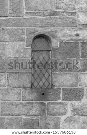 On the streets in Barcelona, public places. Elements of architectural decorations of buildings, windows, doorways and arches, texture of the old walls. Black and white retro style photo.