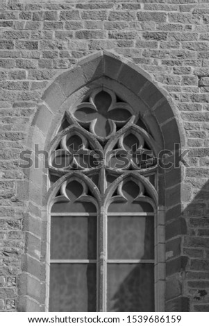 On the streets in Barcelona, public places. Elements of architectural decorations of buildings, windows, doorways and arches, texture of the old walls. Black and white retro style photo.