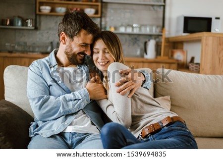 Young happy couple spending their time at home Royalty-Free Stock Photo #1539694835