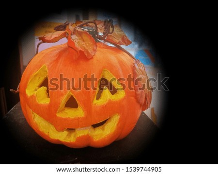 Happy Halloween with scary jack-o-ceramic pumpkin lantern on dark background