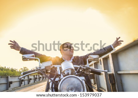 Copy space for inscription Horizontal Young man riding a chopper not holding the steering wheel Copy space for inscription