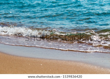 sandy beach and blue sea wave. Beautiful natural background. Tourism and travel
