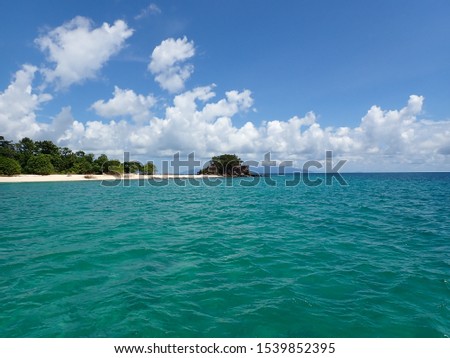 Pictures of islands and beaches with beautiful skies and seas captured from boats.