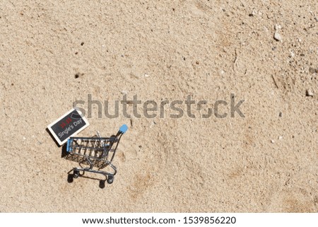Single's day sale concept of China, 11.11. The shopping cart and and the text 11.11 single's day sale with sand background.