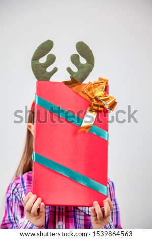 Young girl with at home with Christmas gift boxes, isolated on white background.