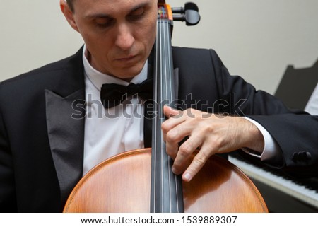 Musicians of the symphony orchestra. Cellist in concert costume. Portrait.