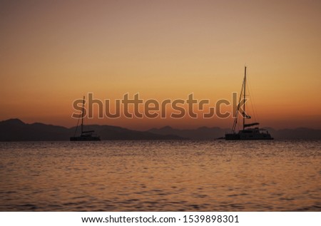 Moored sailing boats in Datca bay at sunset in Turkey