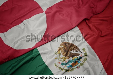 waving colorful flag of mexico and national flag of greenland. macro