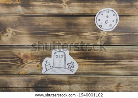 Drawing paper sketch of cemetery on wooden background