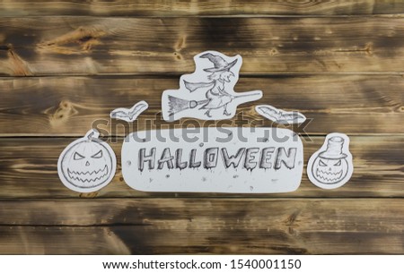 Sketch inscription Halloween, evil pumpkin and whitch on wooden background