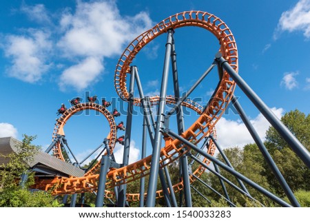 Ferris wheel and roller coaster, France Royalty-Free Stock Photo #1540033283