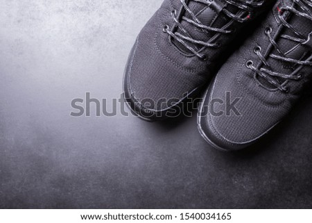 Black men's sneakers close-up on a black isolated background. Royalty-Free Stock Photo #1540034165
