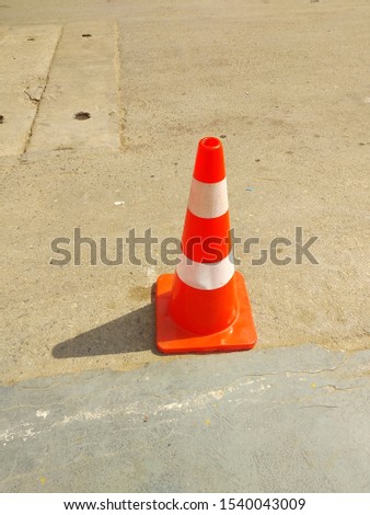 An orange colored traffic cone