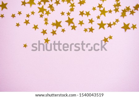 Pink pastel festive background with confetti. Christmas holiday background. Flat lay