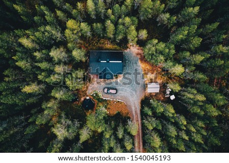 Aerial view of secluded cottage in the woods. Log cabin in the forest in rural Finland. View from above. Royalty-Free Stock Photo #1540045193