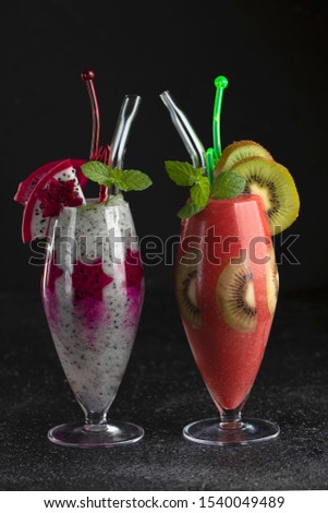Two glasses of tropical cocktails. Party cocktail bar. Dragon fruit. Watermelon. Kiwi.