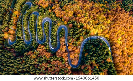 Aerial view of mountain curved road with truck heavy traffic. Beautiful asphalt serpentine roads details 