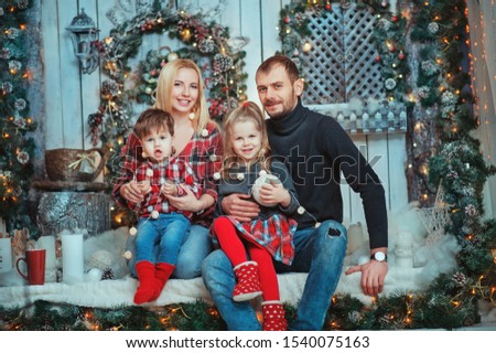 Christmas Family Portrait In Home Holiday Living Room, Kids and parents With Present Gift Box and lights, House Decorating By Xmas Tree Candles Garland