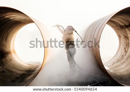 Sandblasting or abresive blasting for steel pipes before painting and coating.