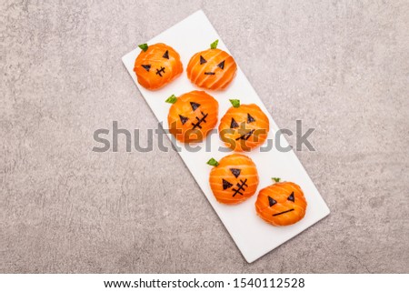 Funny Halloween Sushi Pumpkins Jack o Lantern, Sushi Monsters. Temari sushi, sushi balls. Healthy food for kids. Ceramic plate, stone concrete background, copy space, top view