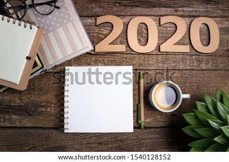 Office desk table with notebooks, coffee cup, american flag. New year 2020 resolutions or goals list. Goal, plan, strategy, politics, international relations, economics, american history concept
 Royalty-Free Stock Photo #1540128152
