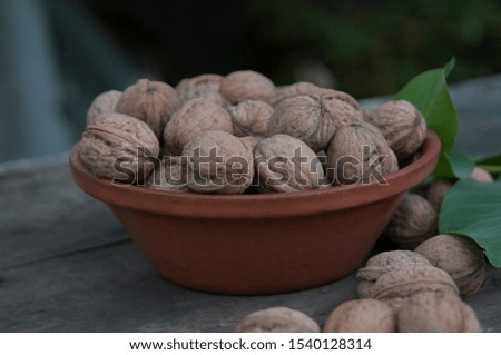 
walnuts with leaves on a wooden table