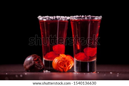 Red alcoholic halloween shots with sweets