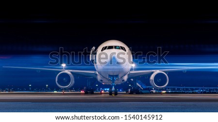 Parked aircraft in night with moving light Royalty-Free Stock Photo #1540145912