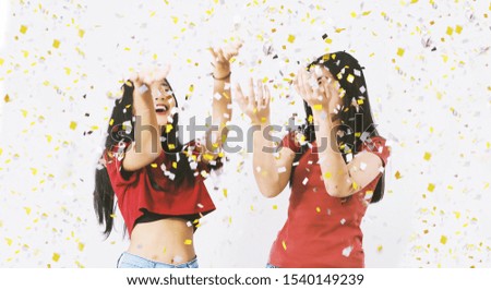 Happy young woman standing over white background with glitter paper,celebration concept.
