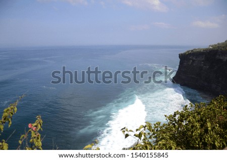 Overview panorama ocean shore and cliff over the Indian ocean at Pura Luhur Uluwatu Temple, Bali