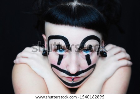 Sad clown girl. Halloween mask.