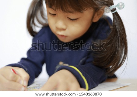 Japanese girl drawing a coloring book (4 years old)