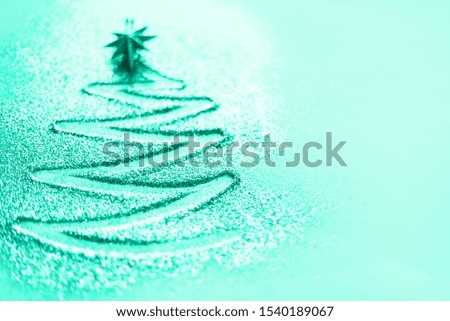 Greeting card with copy space. Christmas tree with defocused lights, bokeh on mint color background. Trendy green and turquoise color. Winter, new year concept