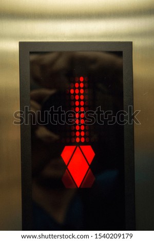 Sign 1st floor in the elevator. Red number.