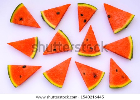 Creative scandinavian style flat lay top view of fresh watermelon slices on white table background copy space. Minimal summer fruits pattern for blog or recipe book

