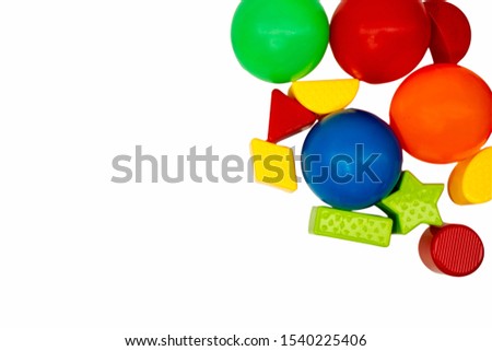 Colorful vivid toys frame on white background with copy space. Colourful balls and building block toys. Kid educational development concept.