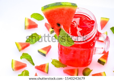 Creative Scandinavian-style flat, placed the top view of fresh watermelon slices, drinks in a glass on the copy space, white background, square  Minimal summer fruit concept for a blog or cookbook