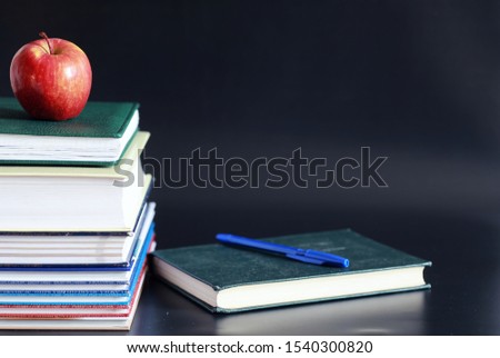 A stack of textbooks and books on table. The concept of knowledge and education.