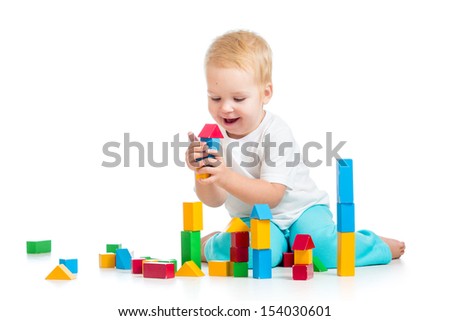 child girl playing with block toys over white background