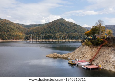 Dam and reservoir on Lake Vidraru. Hydropower construction, waterworks Dam Vidrau on Transfagarash highway in Romania, autumn