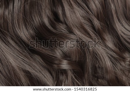 Single piece clip in black wavy synthetic hair extensions Royalty-Free Stock Photo #1540316825
