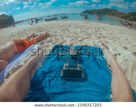 Drone and remote controller on the beach in Thailand