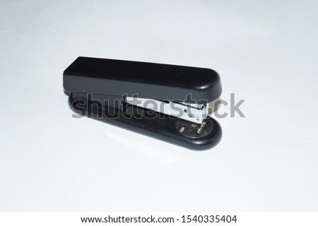 black stationery stapler on white background