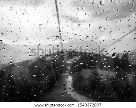 raindrops on the glass.  Natural drawing of a raindrop on an old window pane.  abstract black and white background