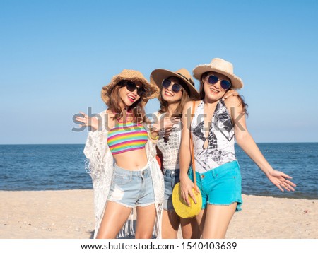 Group of women wearing hat enjoying on the beach, lifestyle concept