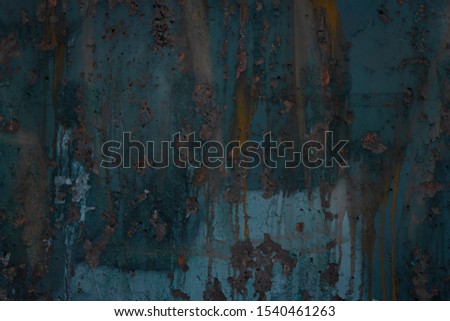Abstract art texture background. Creative wall art close up. Beautiful dark background. Paint on the wall. Blue, grey, orange and yellow old cracked concrete wall surface