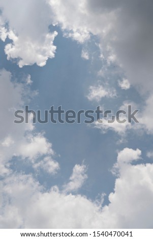 Summer blue sky with soft clouds that looks like white cotton candy. This cloud is called Cumulus in meteorology. Geographic location can be anywhere, but they surely reminds us of natural beauty.