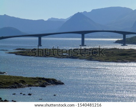 picture with bridge silhouettes, and solar glares of light on the water surface