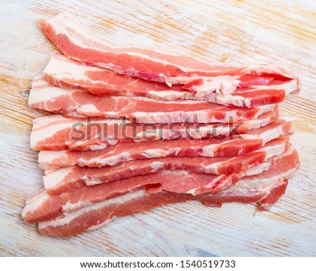 Close up of raw  bacon steaks on wooden surface, nobody