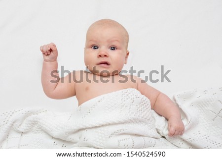 Confused surprised baby infant boy three months old with funny face at isolated background Royalty-Free Stock Photo #1540524590
